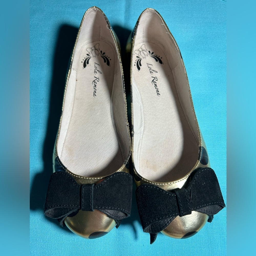 Lola Ramona gold leather ballet flats with black polka dots and black suede bow.
